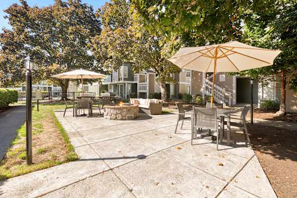 A sunny day at the park with a yellow umbrella and a fire pit. at AVIA Lofts on Parkway, Vancouver, 98662